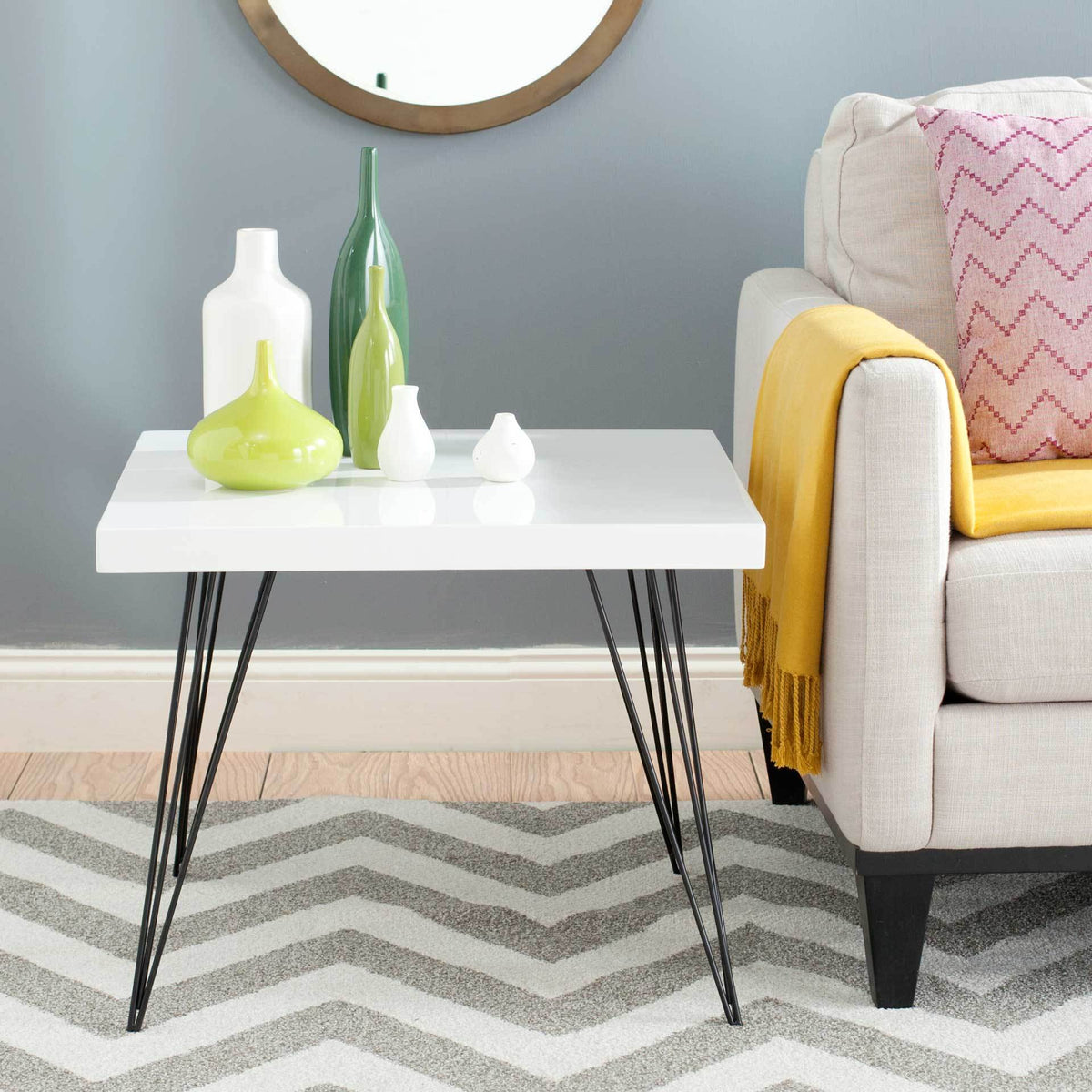 Compact square coffee table pairs a bright white top with airy black metal legs