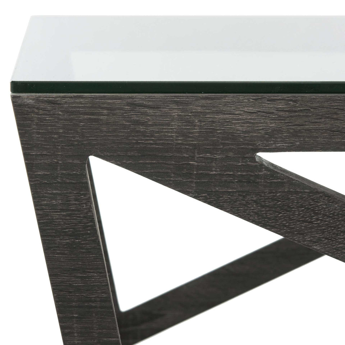 The glass tabletop meets a textured dark gray frame with sharp geometric lines.