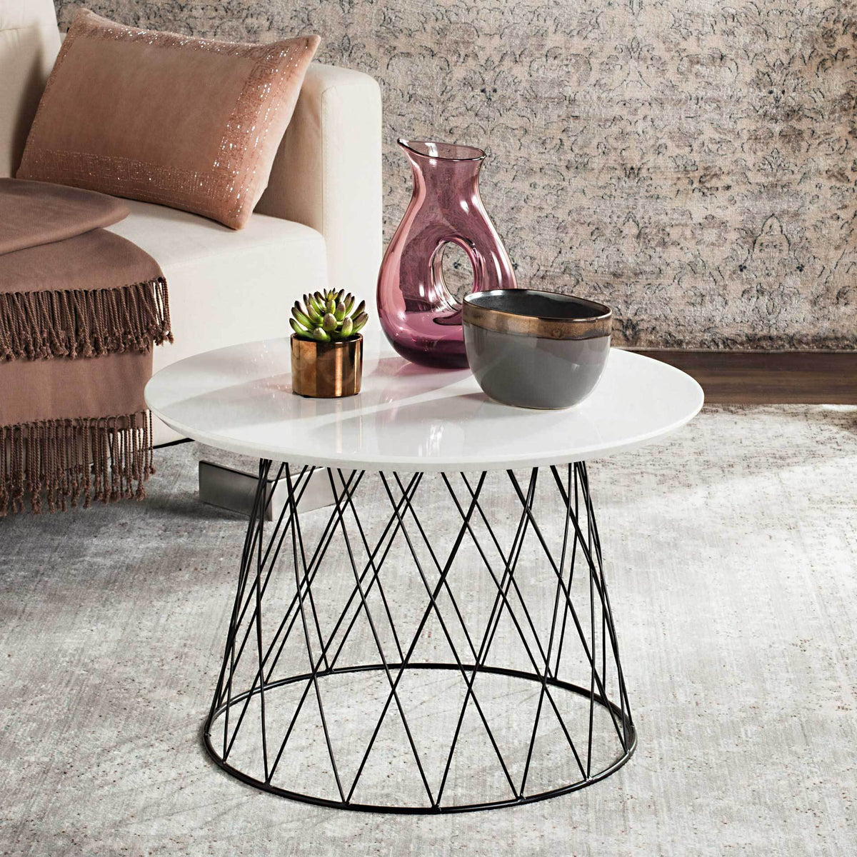 A white lacquered top and sculptural black wire base add sleek contrast to a living room.