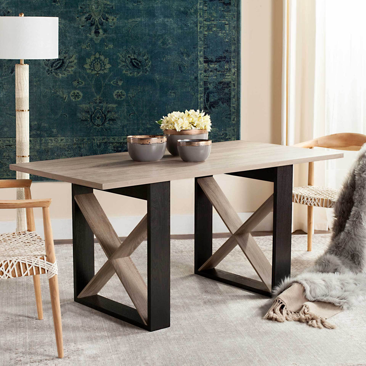A light gray dining table brings contrasting black frames and wood X-braces to the dining space.