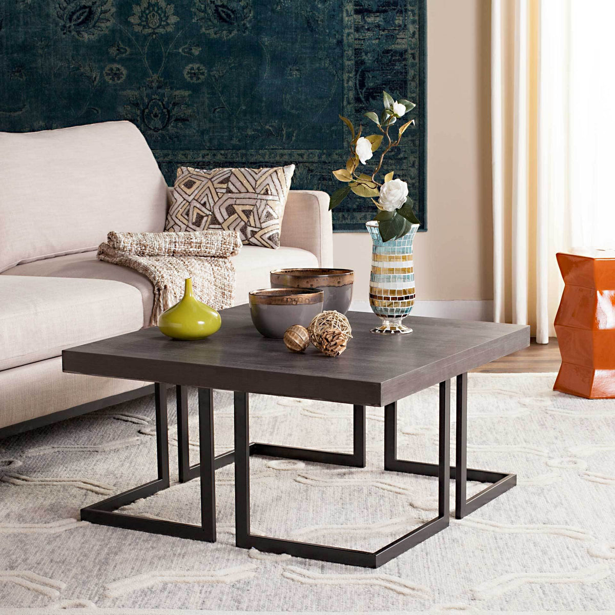 A dark gray square top and open black metal base bring modern style to a living space