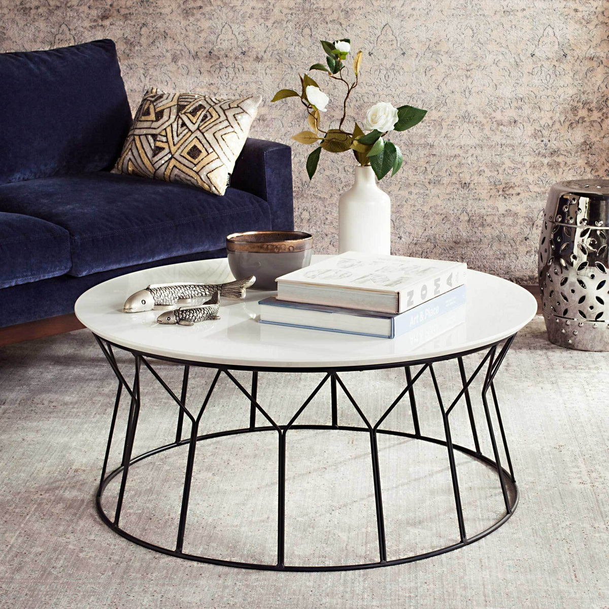 A generous white tabletop and sculptural black wire base bring modern style to a living room