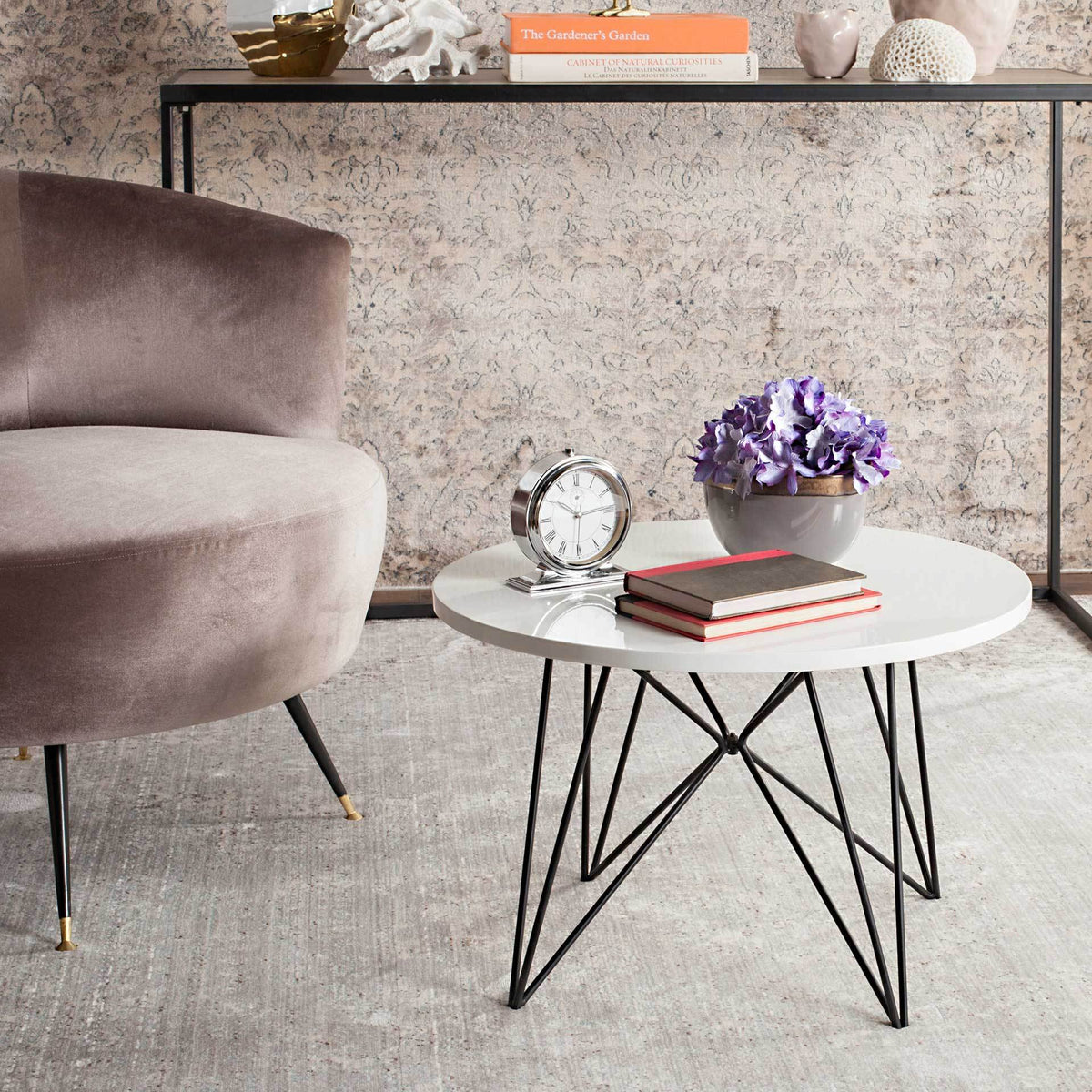A white round top and slender, angular black legs bring airy contrast to a cozy room.