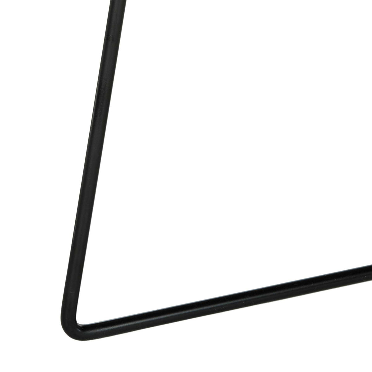 A narrow black iron leg curves into the low, angular foot of the table.