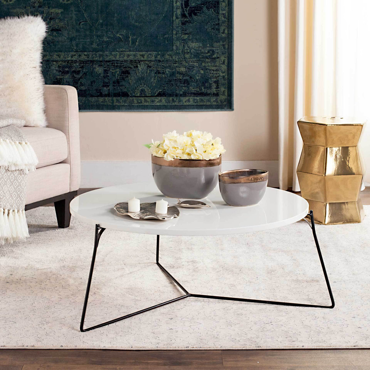 Wide white tabletop holds decorative accents above a delicate, geometric black metal frame.