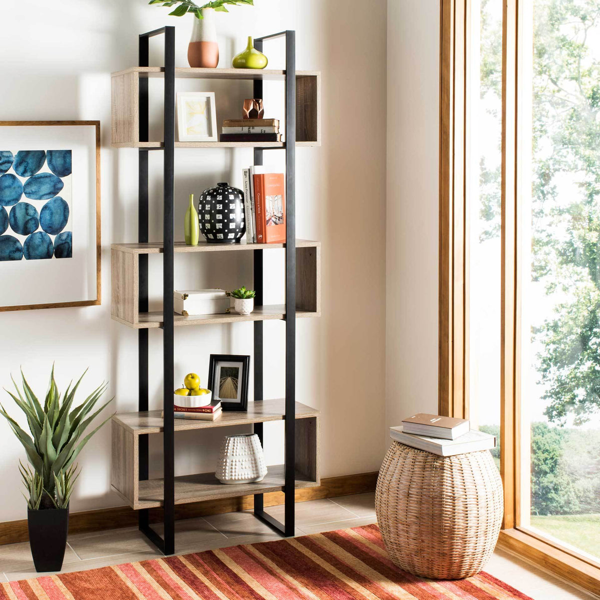 Open wood-look shelves hold books, plants and decor within a slim black metal frame.