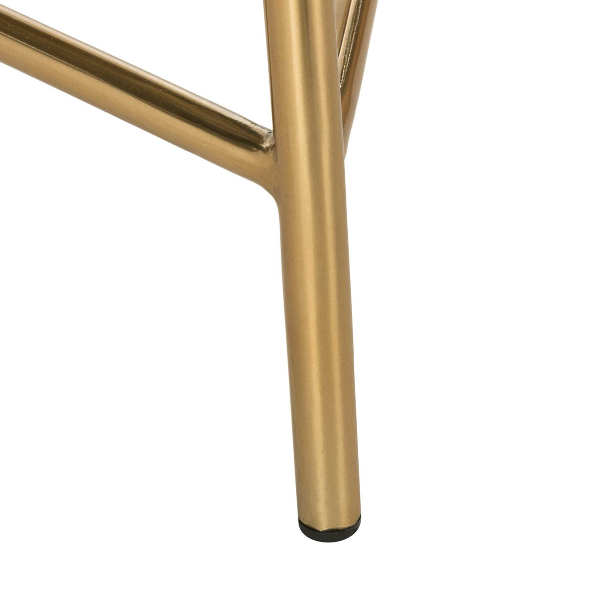 A gold-finished tubular leg joins the angled footrest and rests on a dark foot cap.