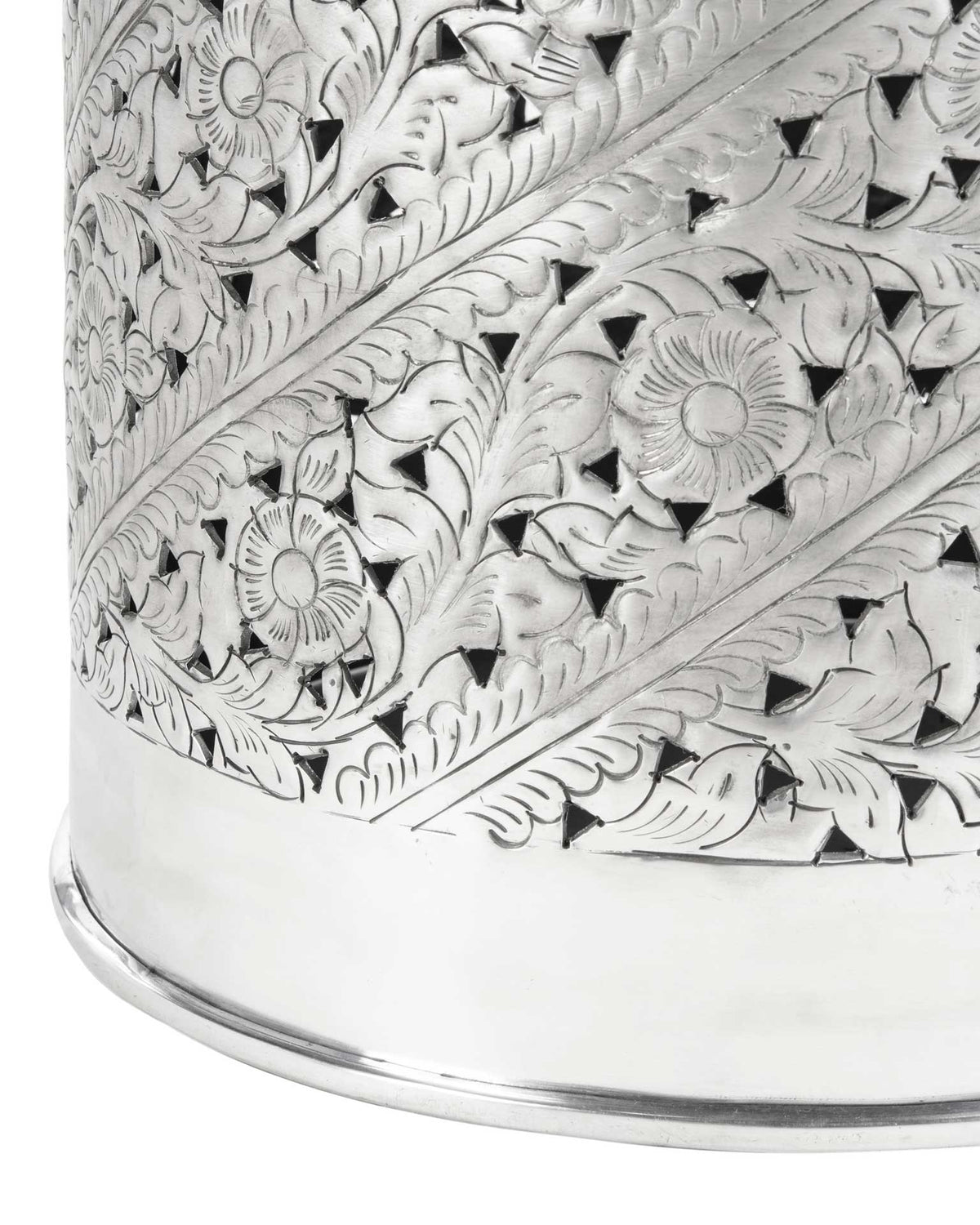 Detailed floral cutouts meet a smooth, polished silver base.