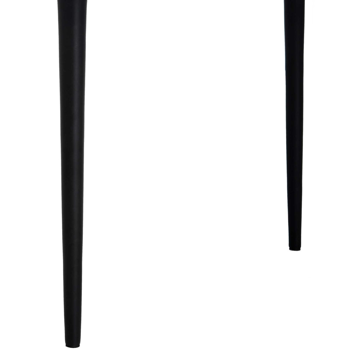 Tapered black metal legs give the side table an airy foundation