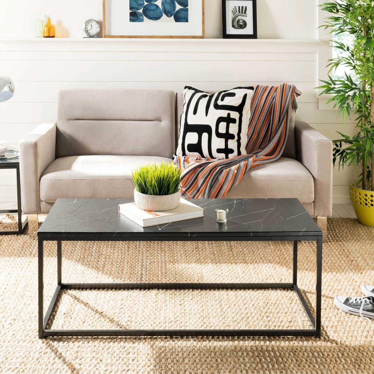 A black veined tabletop and minimalist metal frame lend a modern edge to the living room