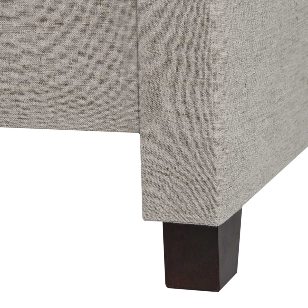 Espresso-finished block foot supports a tailored light gray linen bed frame