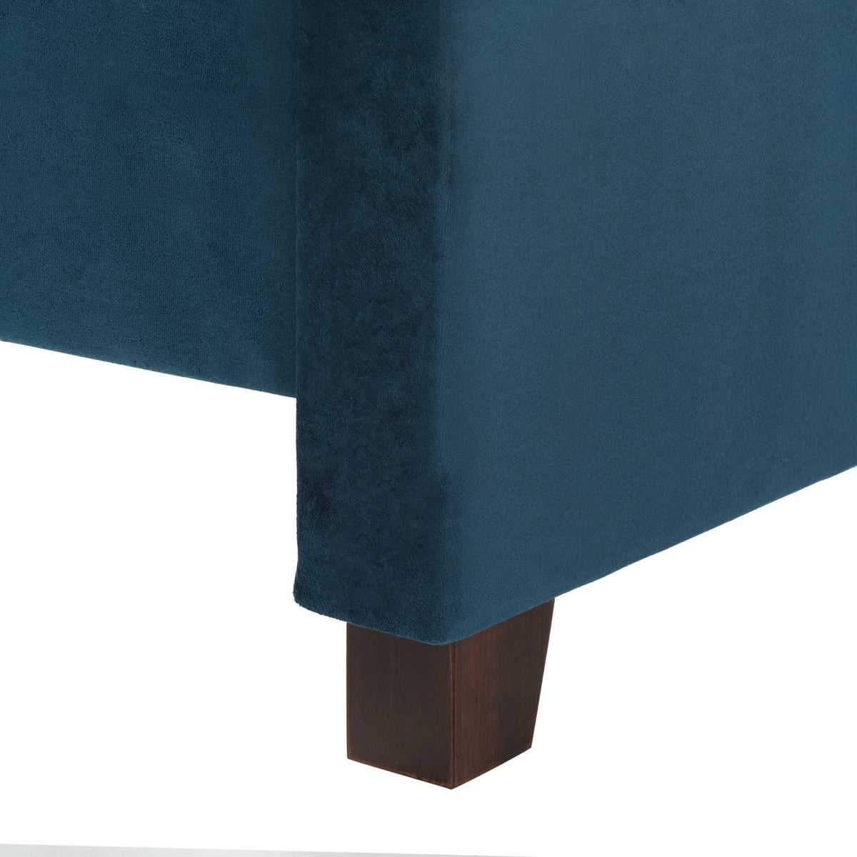 Dark espresso wood foot supports a plush navy velvet upholstered bed frame