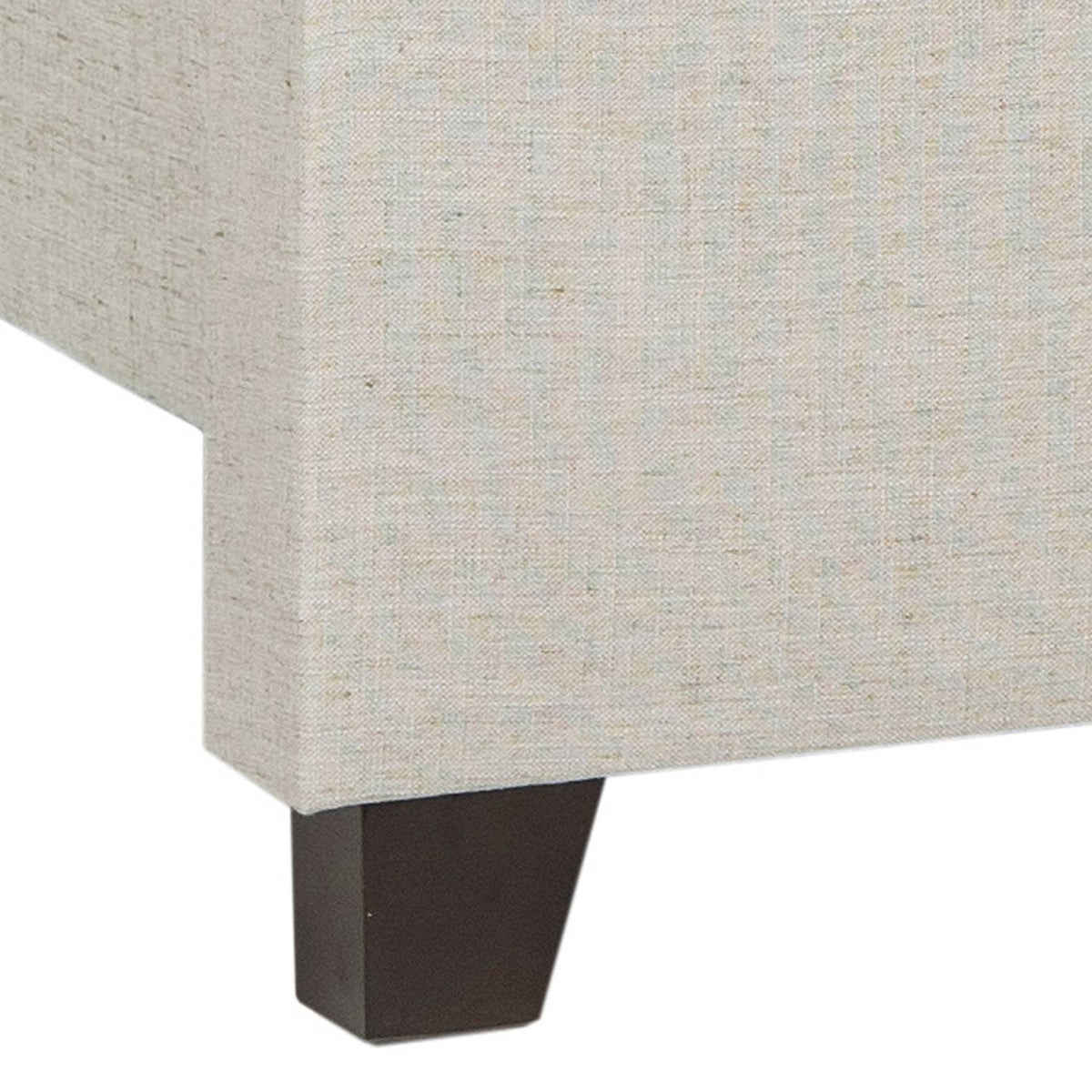 A tapered espresso-finished foot supports the light gray upholstered bed frame.