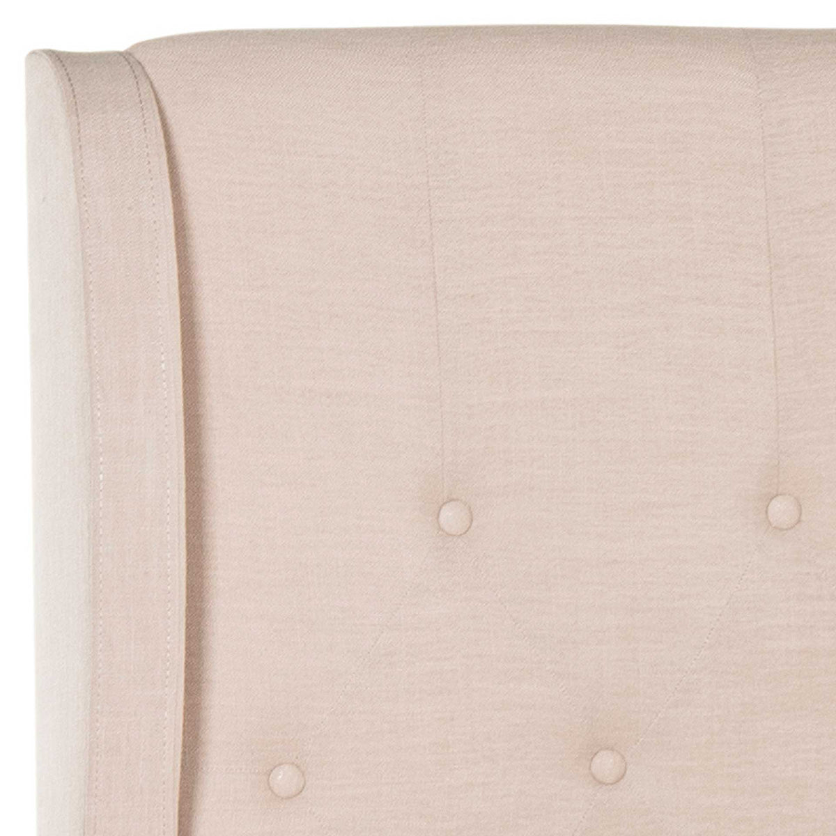 Fabric-covered buttons and a gently curved wing give the beige linen headboard a refined finish.