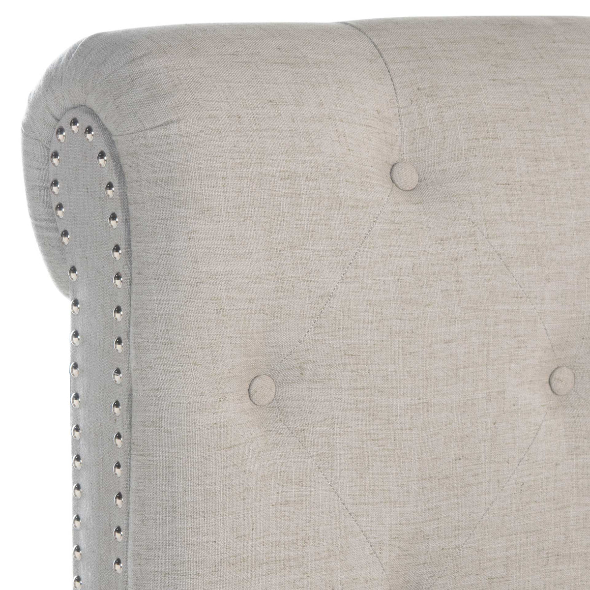Rolled linen headboard with button tufting and gleaming silver nailhead trim