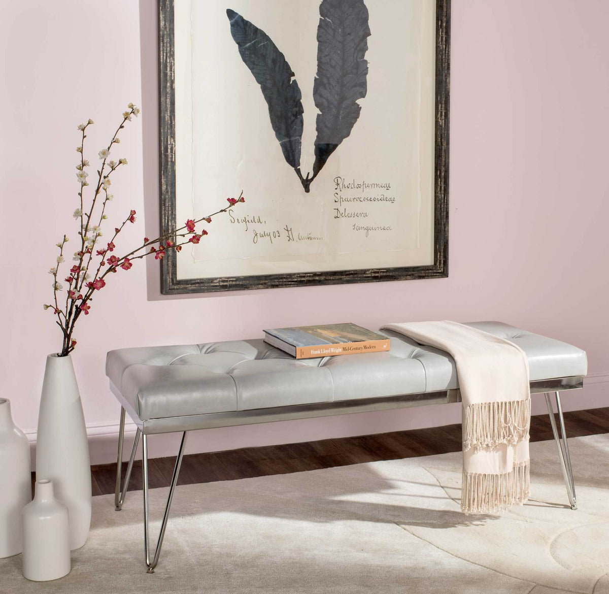 Tufted gray faux leather bench offers a generous perch over slim chrome hairpin legs.
