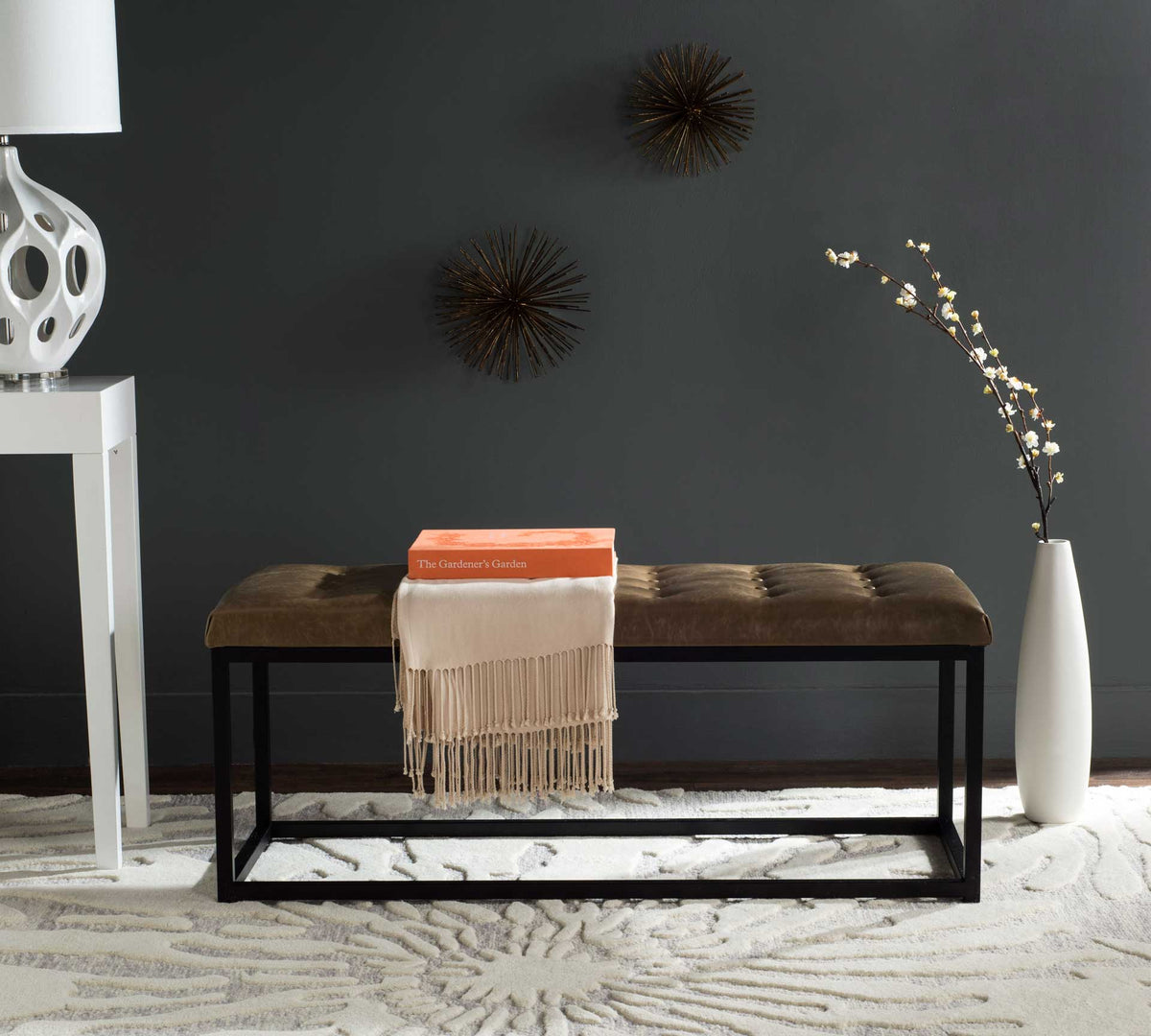 Warm tan upholstery and angular black legs create a modern seating accent.