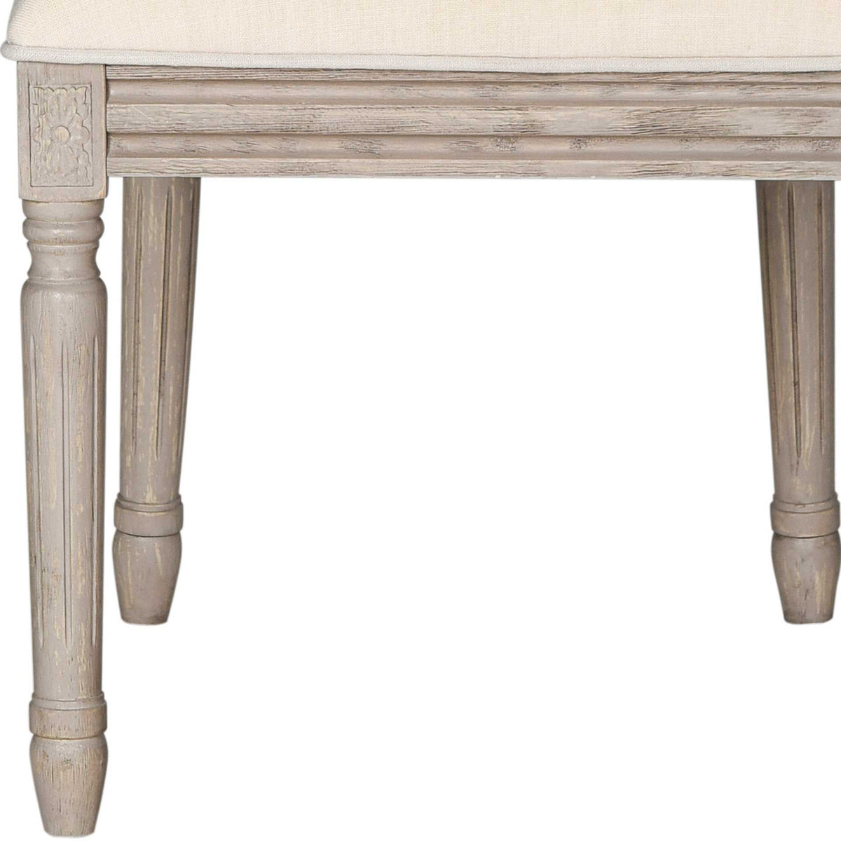 Turned wood legs, carved corner blocks, and a rustic gray finish add old-world character.