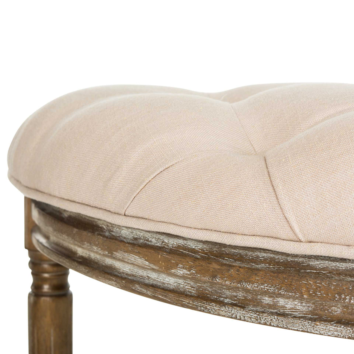 The rounded beige cushion meets a distressed wood frame with gently molded trim