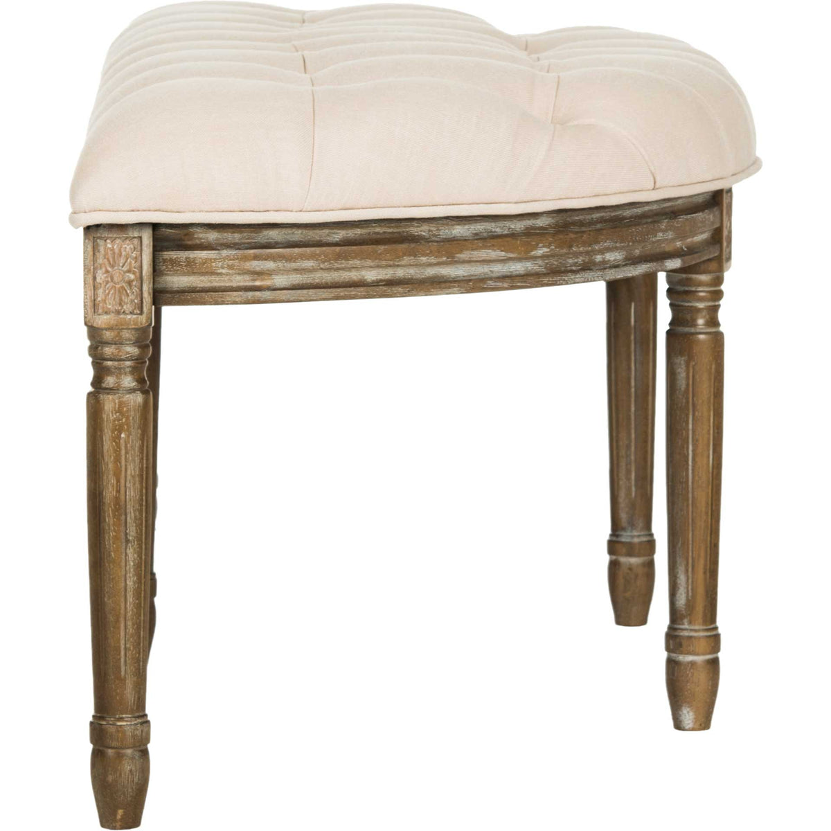Carved wood accents and slender turned legs support a softly tufted beige cushion