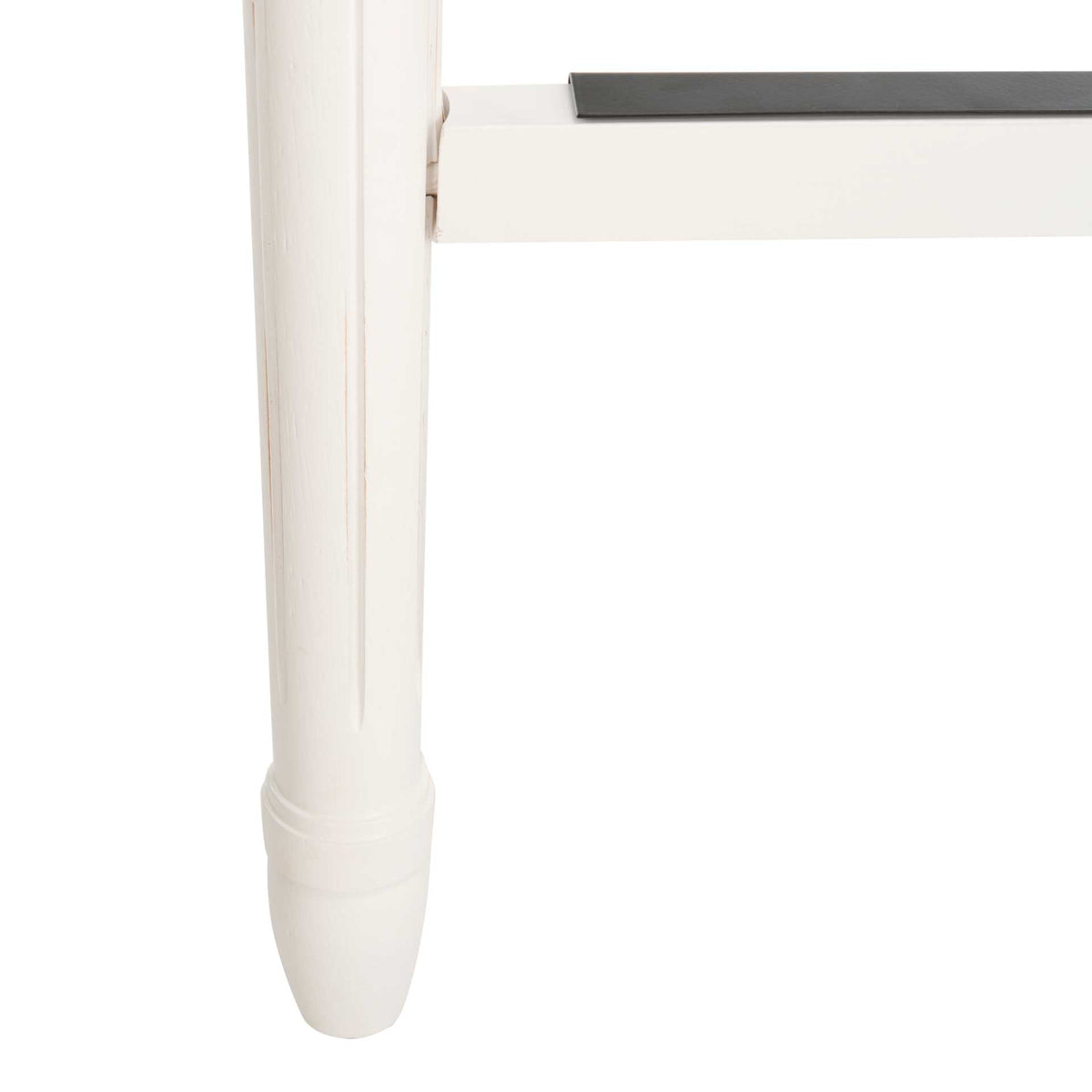 A turned white wood leg supports a footrail with a dark protective metal cap.