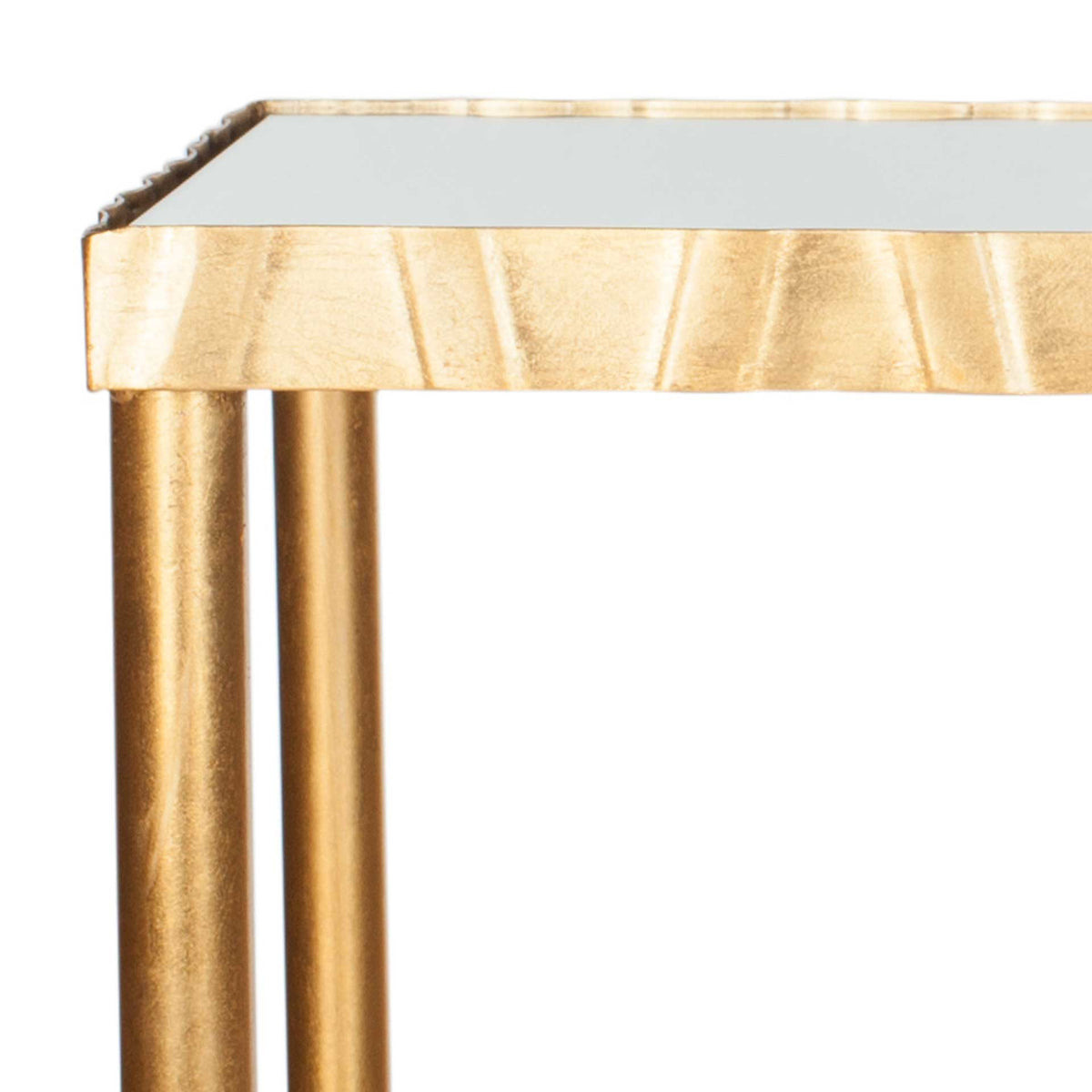 A softly textured gold edge frames the mirror top above slender metallic legs.
