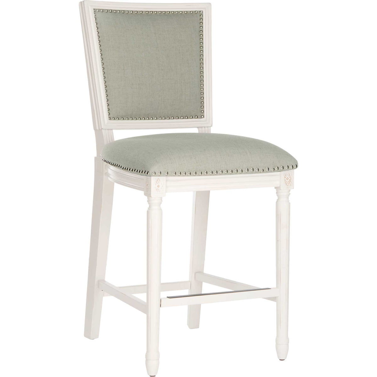 A light gray linen counter stool pairs silver nailhead trim with a distressed white wood frame.