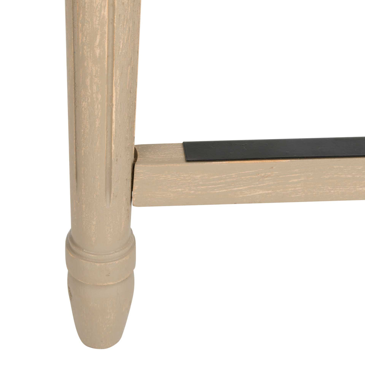 A smooth turned wood leg connects to a footrail with a dark protective strip.