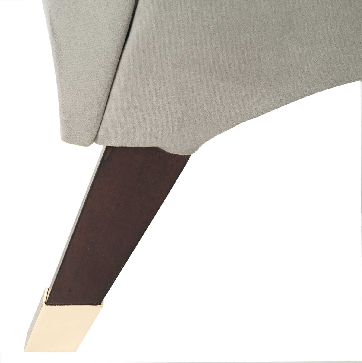 Espresso-stained wood leg tapers to a gold cap below the gray velvet chaise