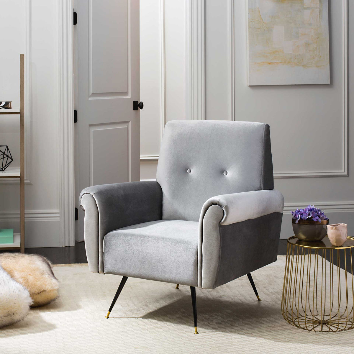 Soft light gray velvet and sculpted rolled arms bring relaxed retro style to this chair