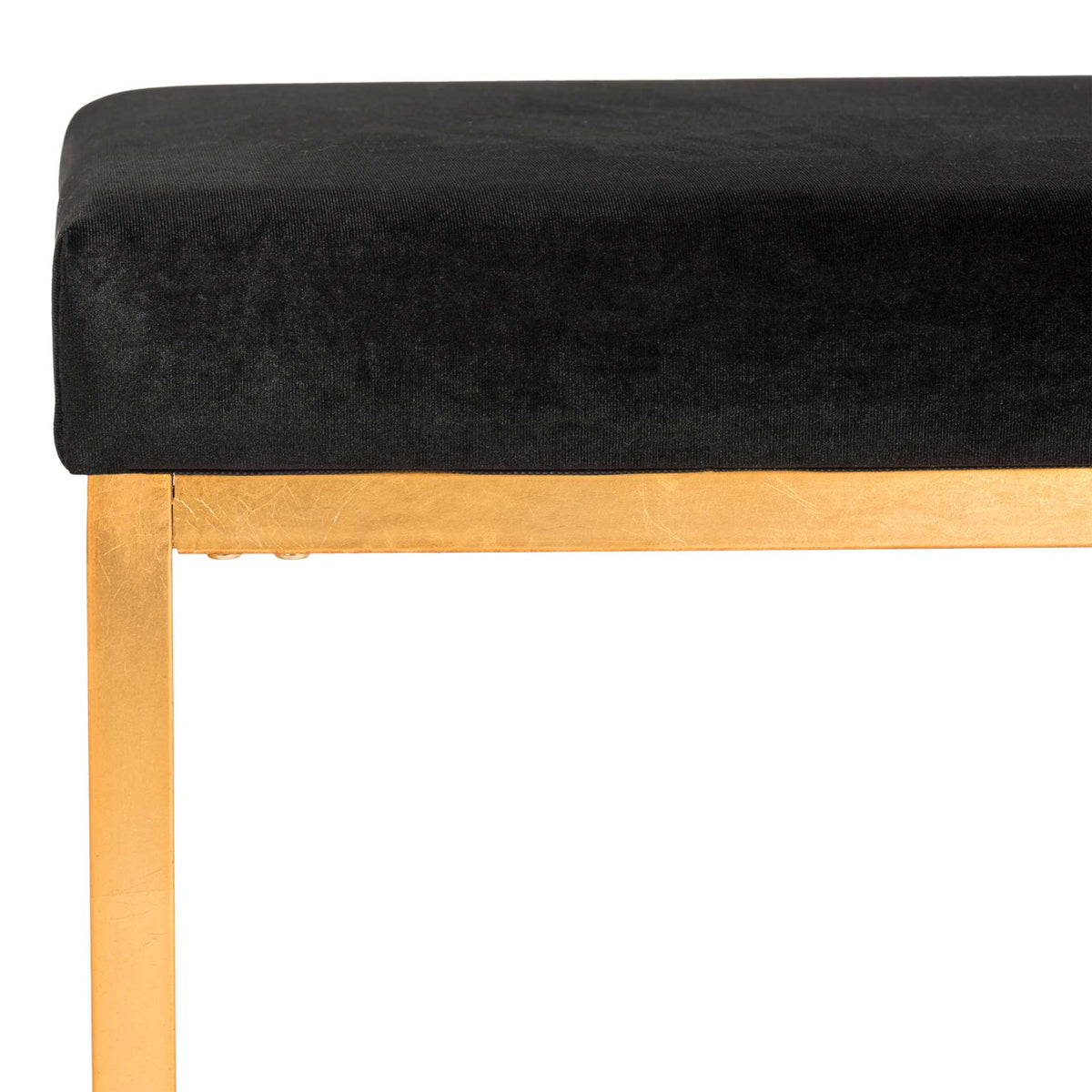 Smooth black velvet wraps the cushioned seat above a sleek gold metal rail.