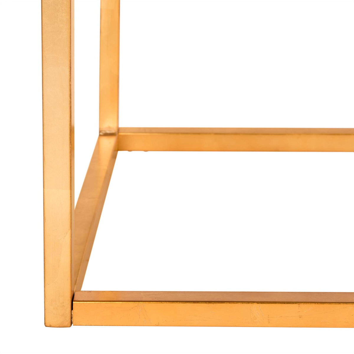 Slim gold metal legs meet a square base for an airy, architectural design.