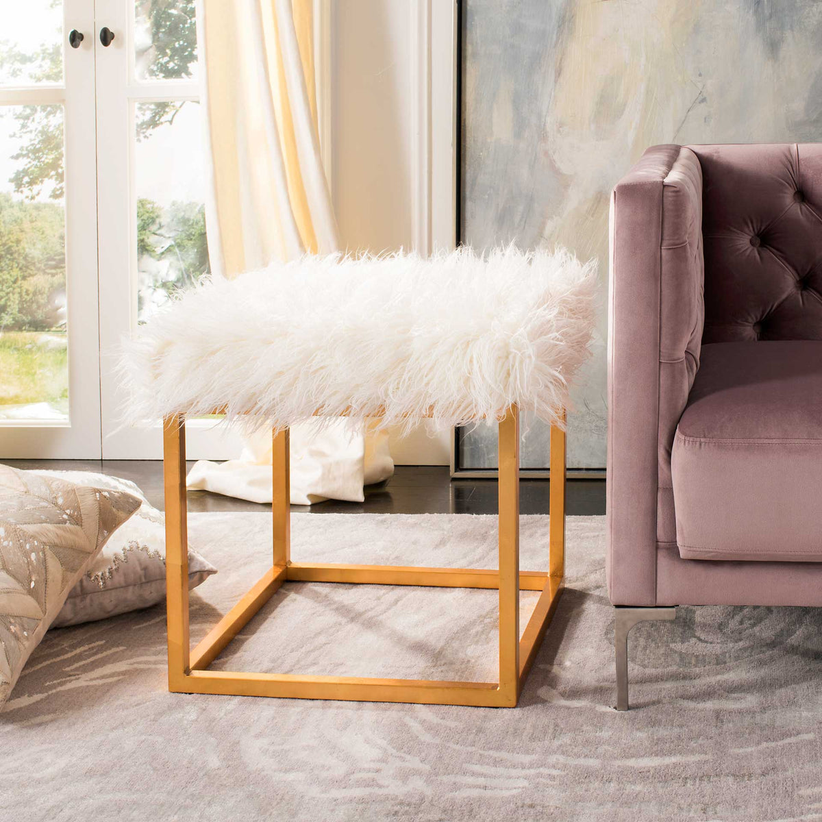 A cloudlike white seat and gold metal frame bring plush texture to the living room.