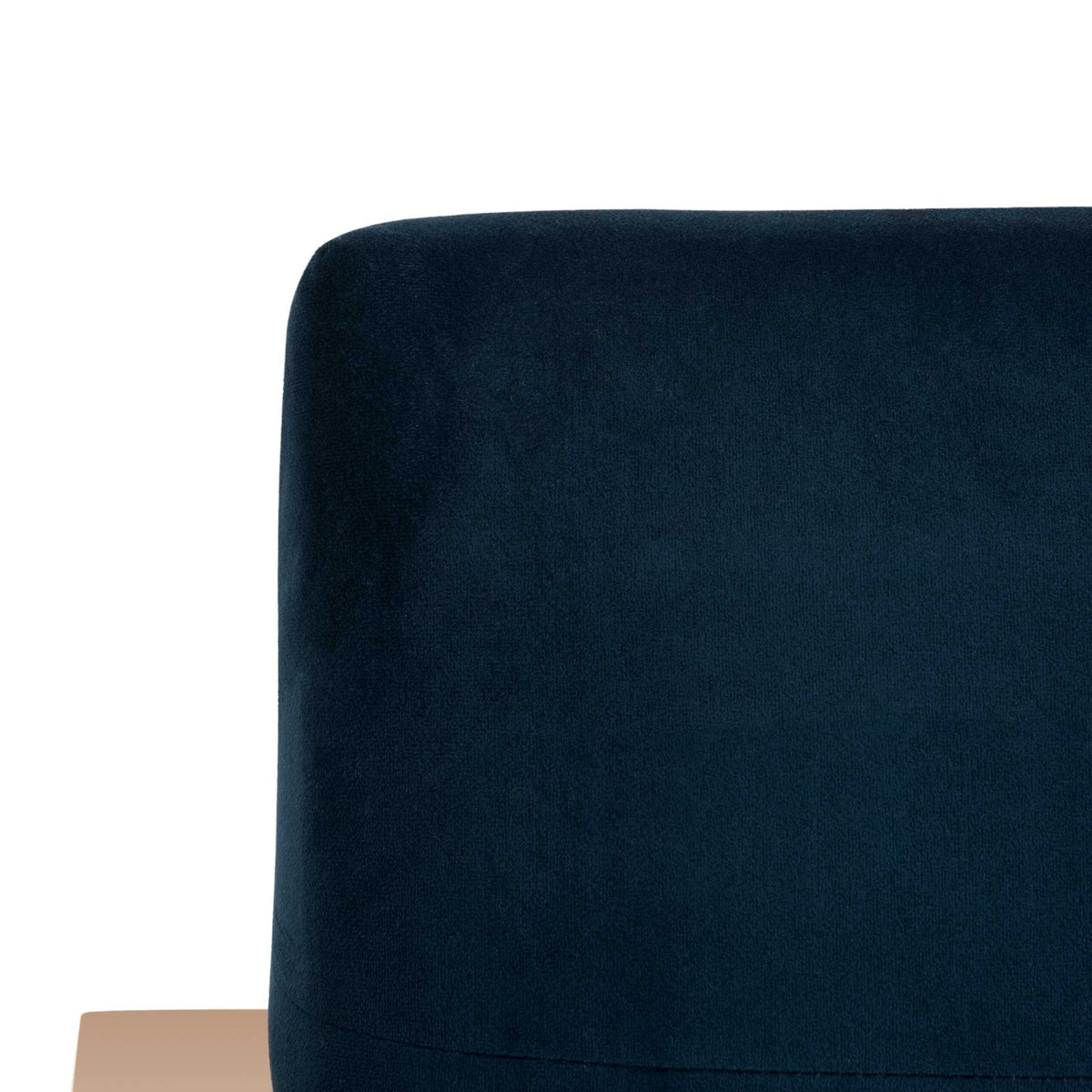Soft navy velvet wraps the gently rounded backrest, finished with a subtle horizontal seam