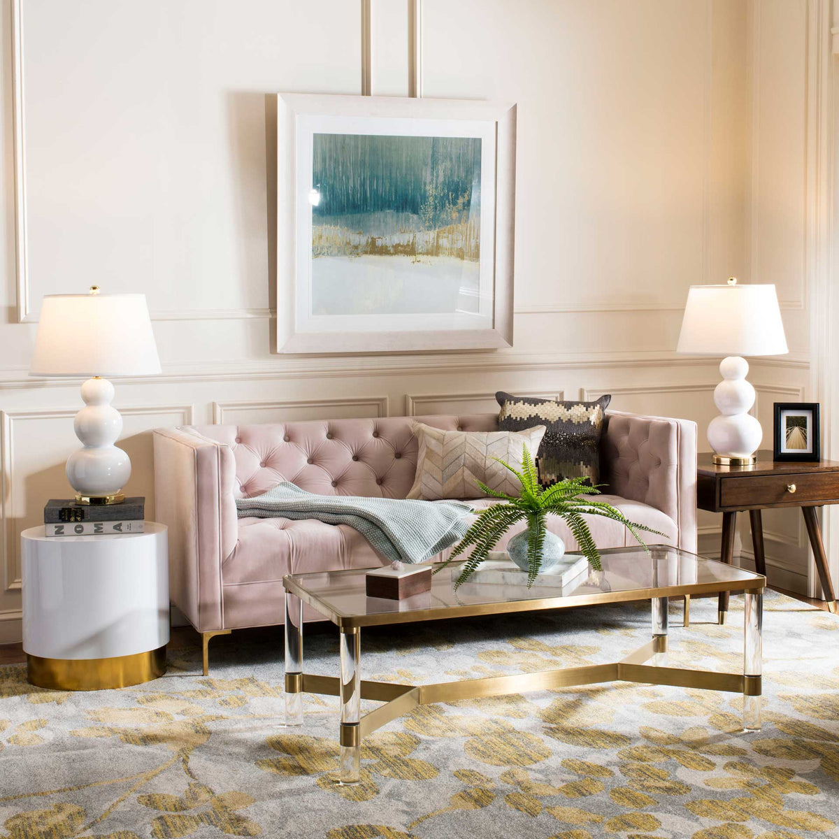 A brown wood end table adds warm contrast to soft upholstery with its gold-accented drawer.