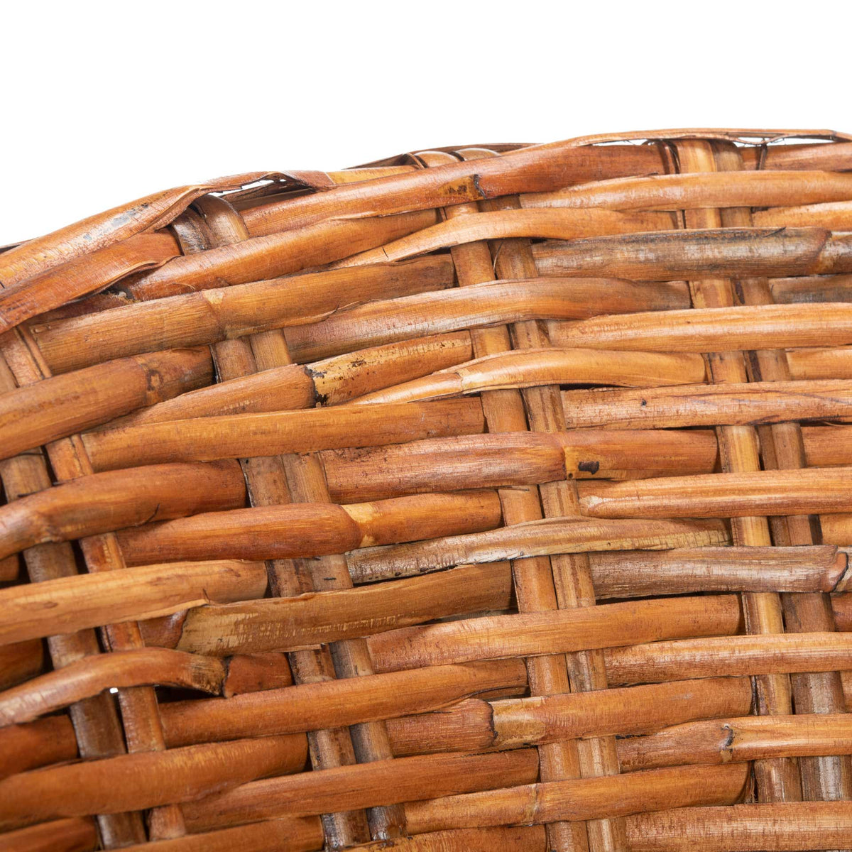 Intricately crossed honey rattan strands define the chair's thick woven rim.