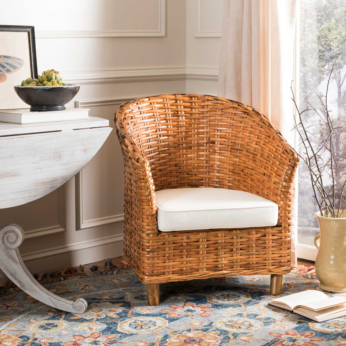 A honey-finished rattan shell embraces a cushioned white seat for laid-back comfort.