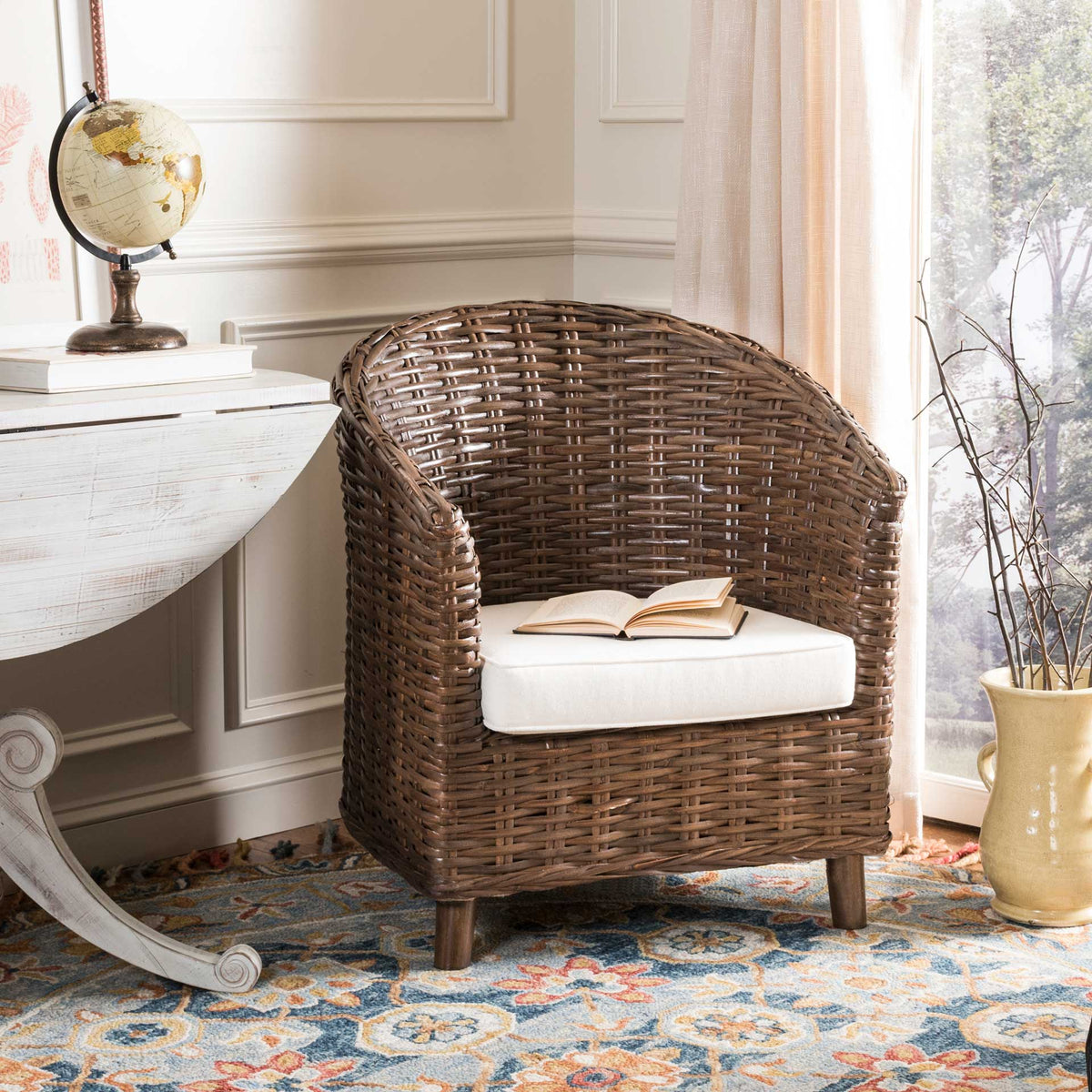 A curved rattan back and plush white cushion create an inviting seat for reading.
