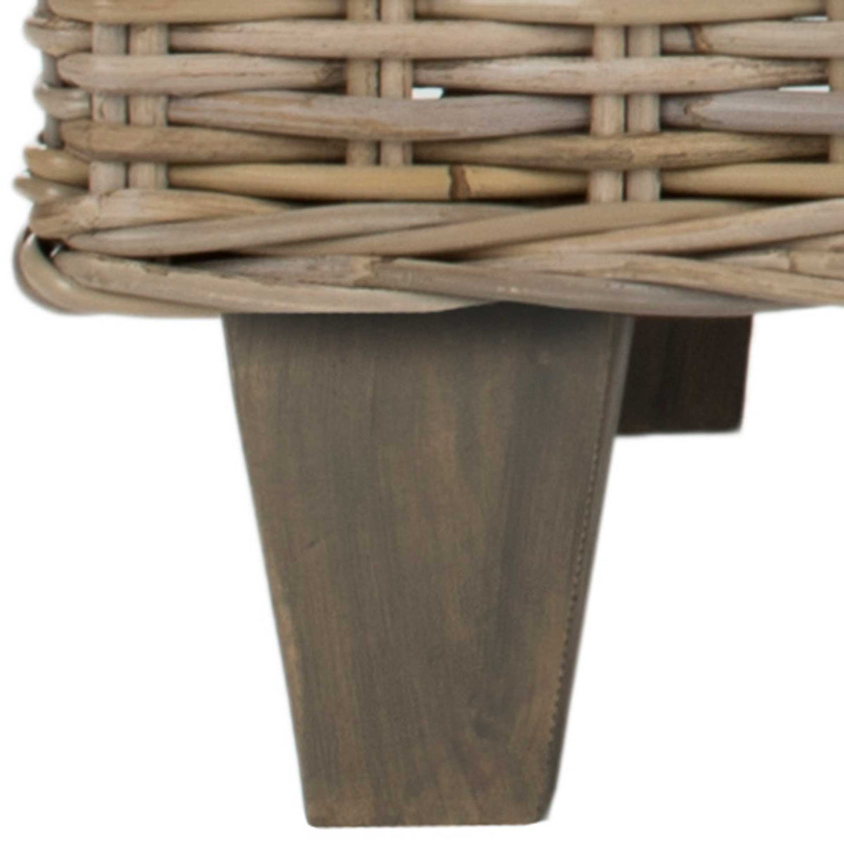 A tapered taupe wood leg adds subtle contrast beneath the pale woven rattan.