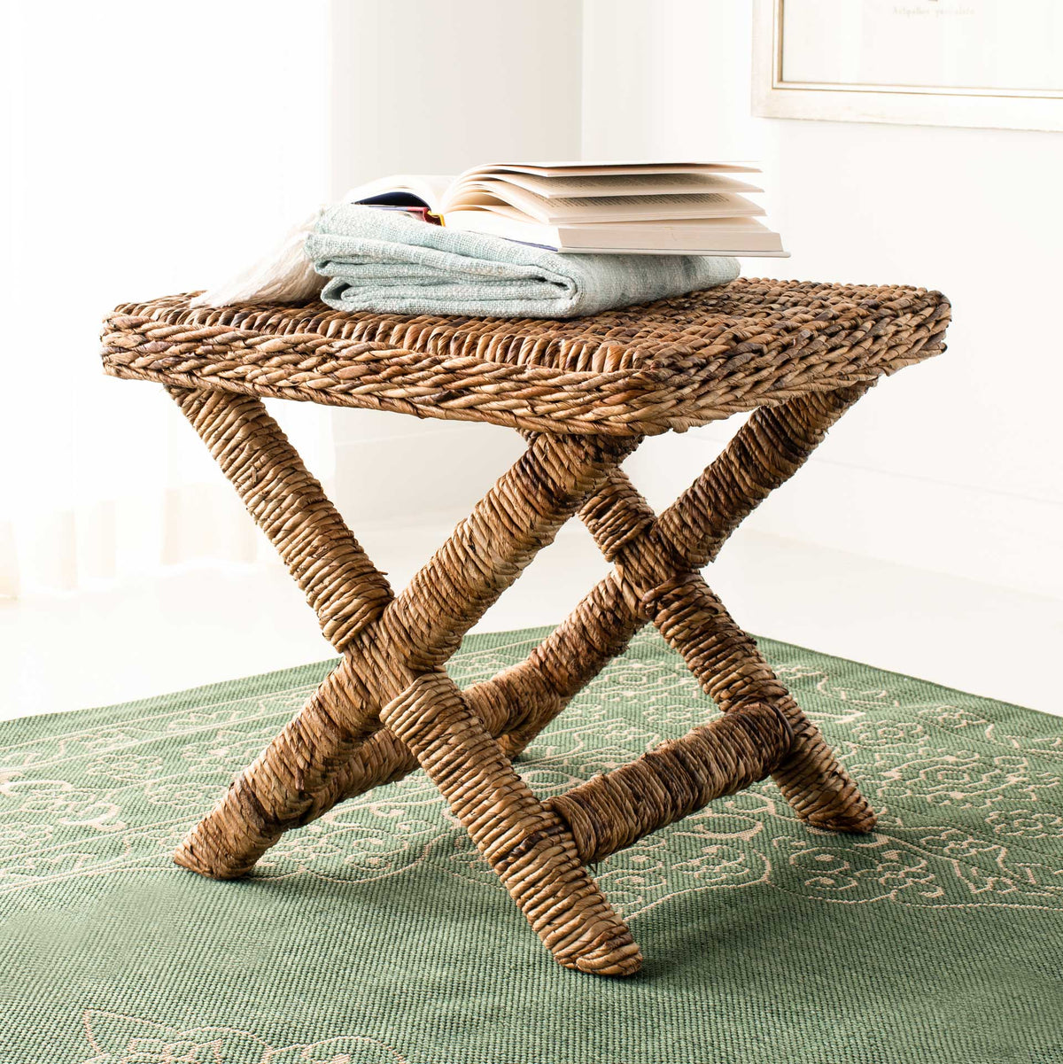 Honey-toned woven ottoman pairs an airy X-frame with a richly textured seat.