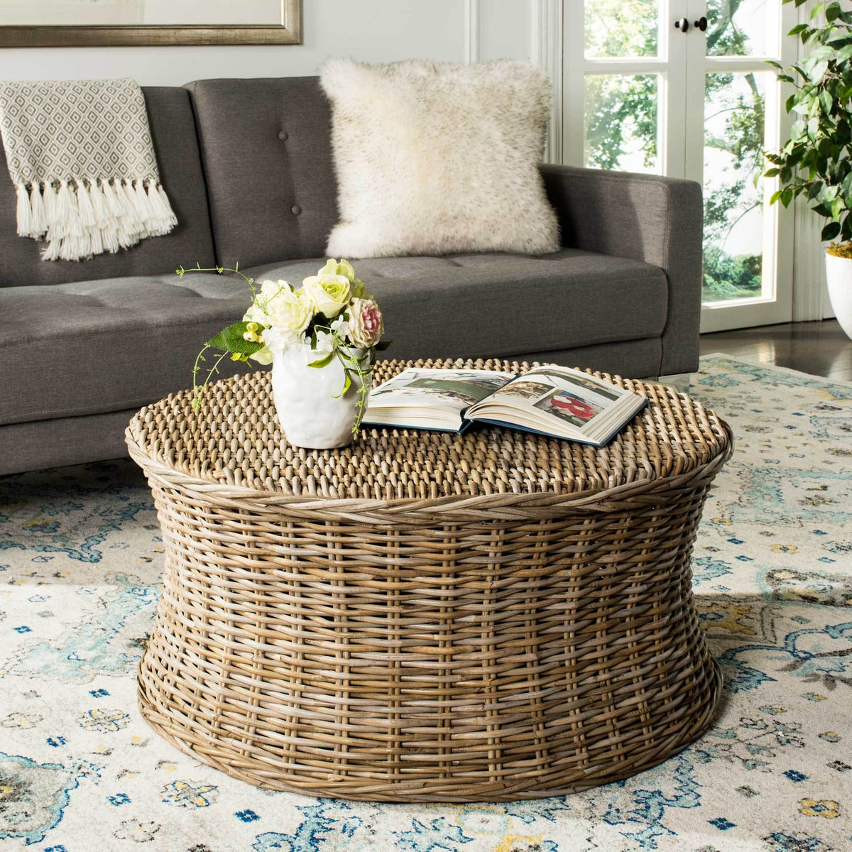 Natural rattan coffee table brings organic texture and a wide woven surface to a living room