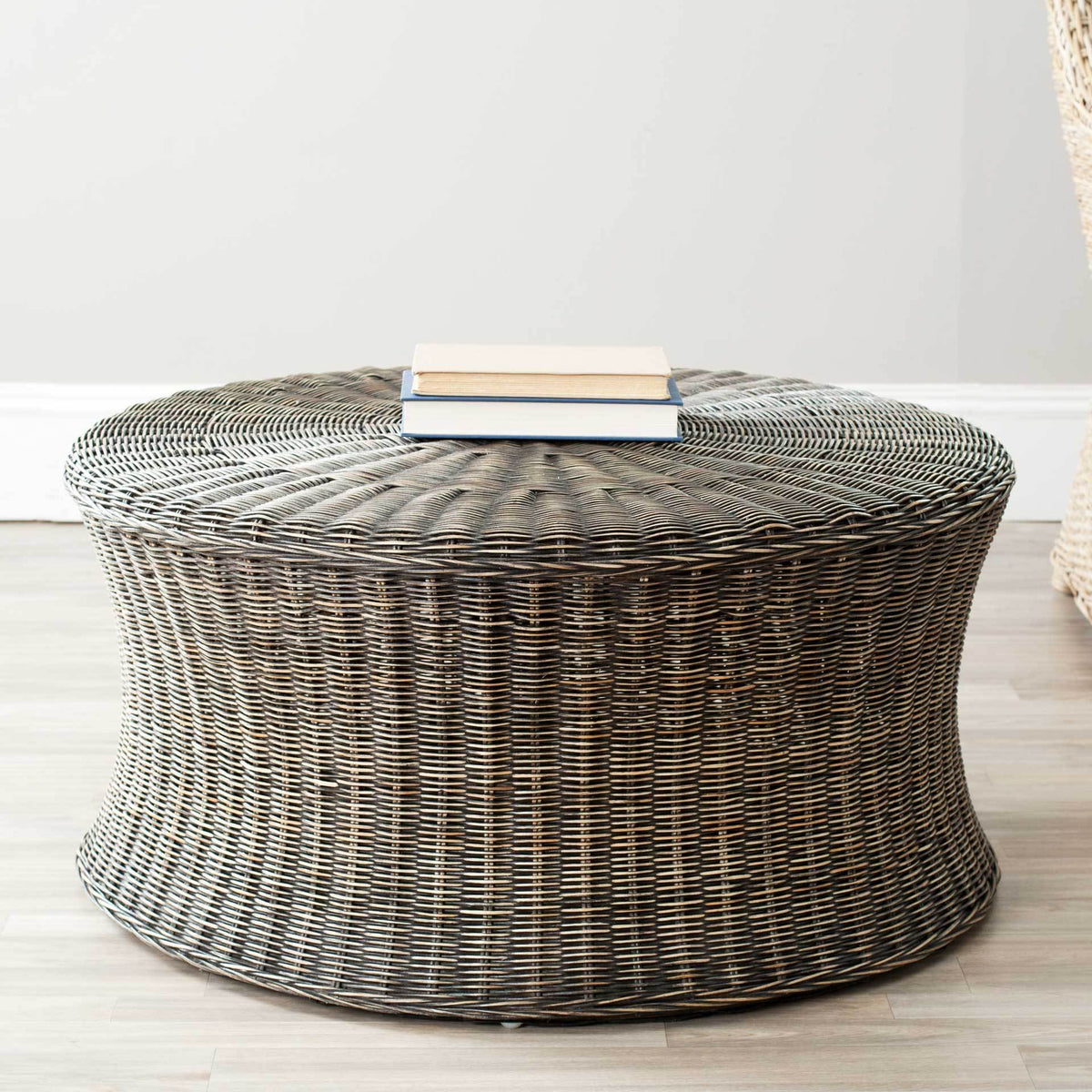 Rich brown woven rattan ottoman doubles as a low coffee table with a spacious round top