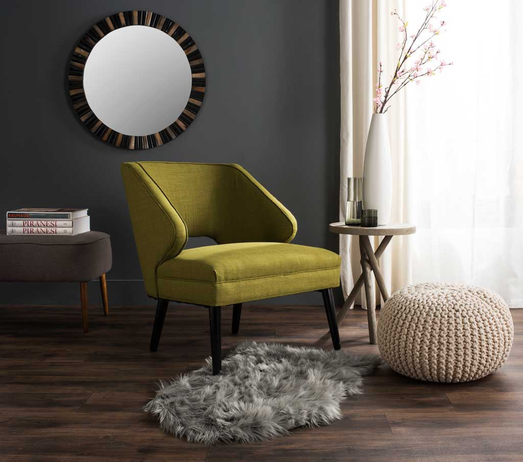 Plush gray faux-sheepskin accent rug adds softness beneath a green chair