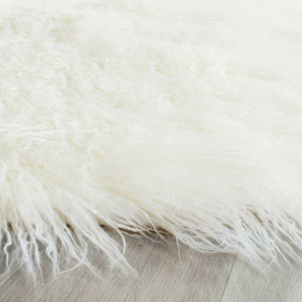 Fine ivory shag fibers cascade along the rug's edge for a light, feathery finish.