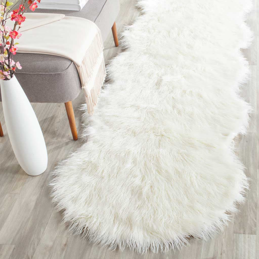 Lush ivory shag and curved edges give this runner inviting softness beside a neutral chair.