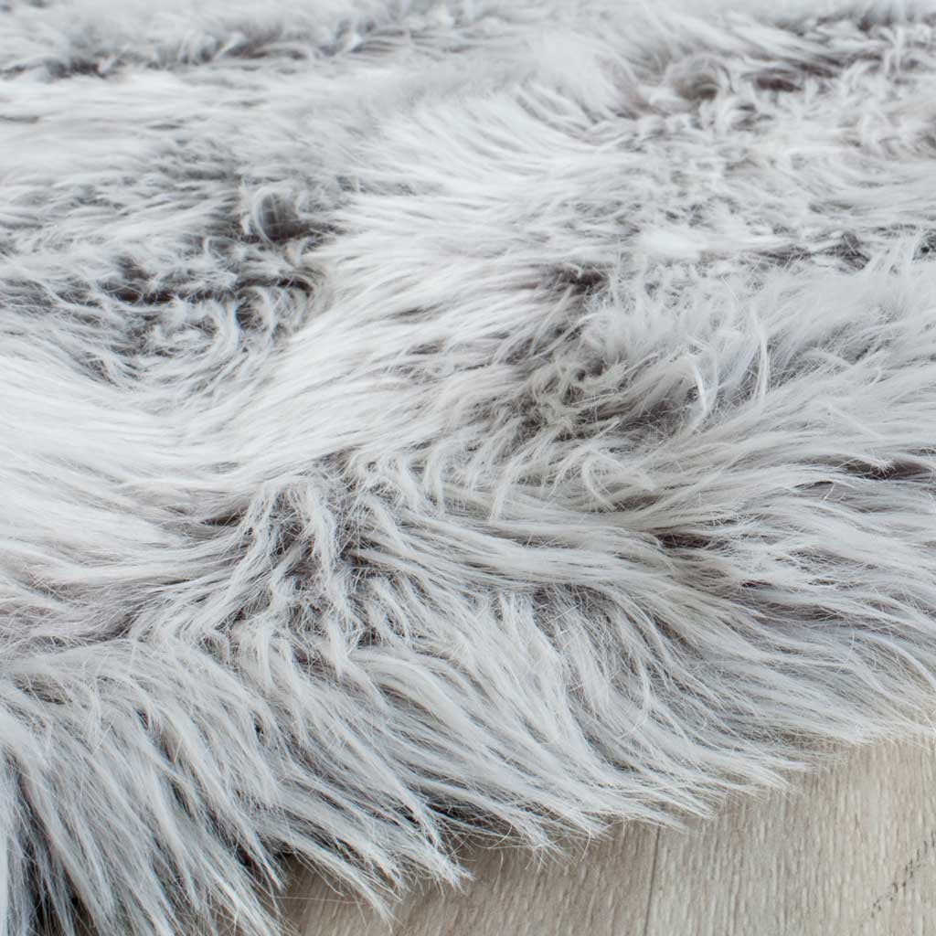 Long, pale gray fibers with darker tips spill over the edge for a soft, airy shag finish.