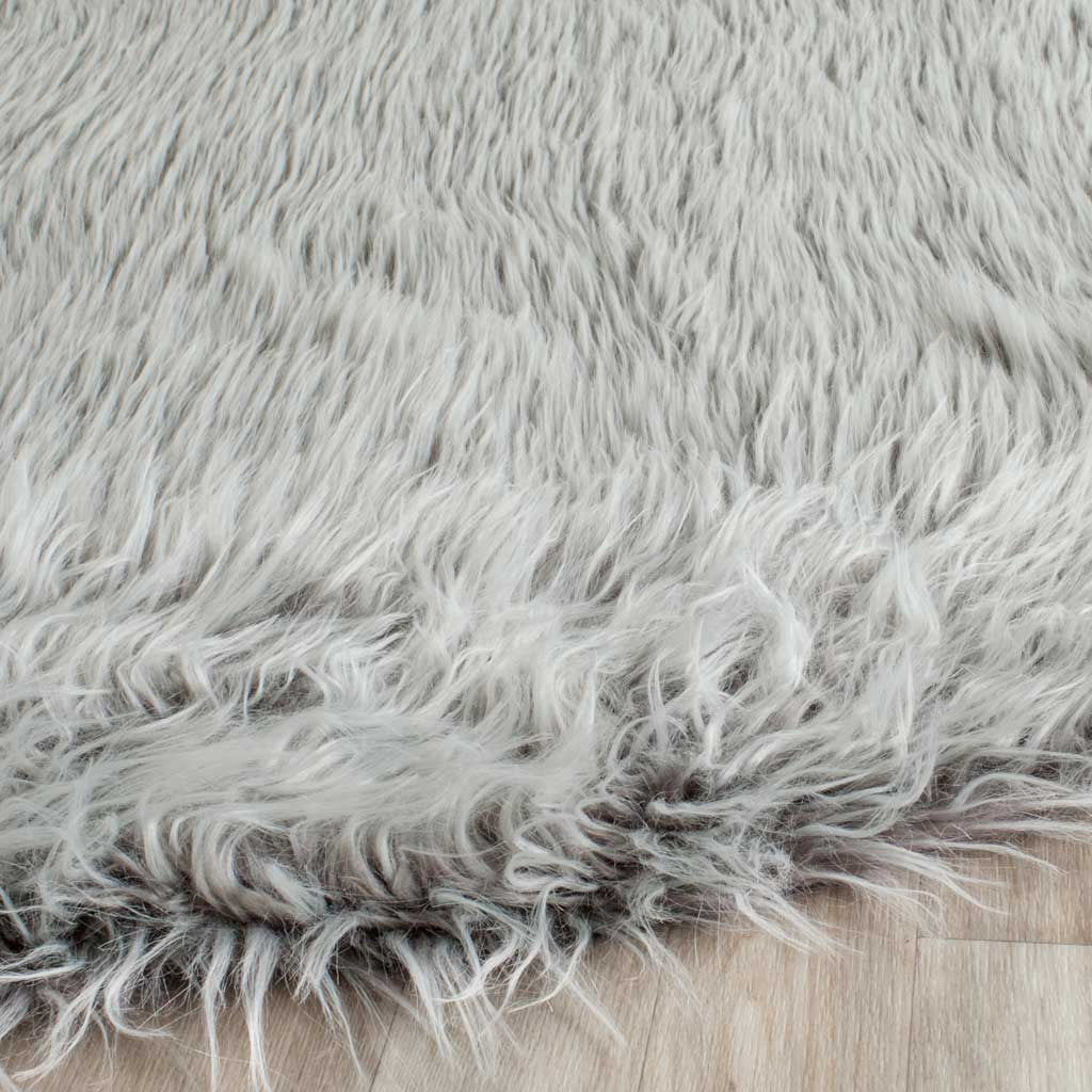 Long light gray shag fibers curl around the rug's edge for a feathery feel