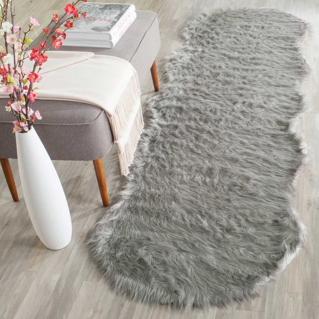 A dark gray shag runner adds plush texture and organic curves alongside a neutral lounge chair.