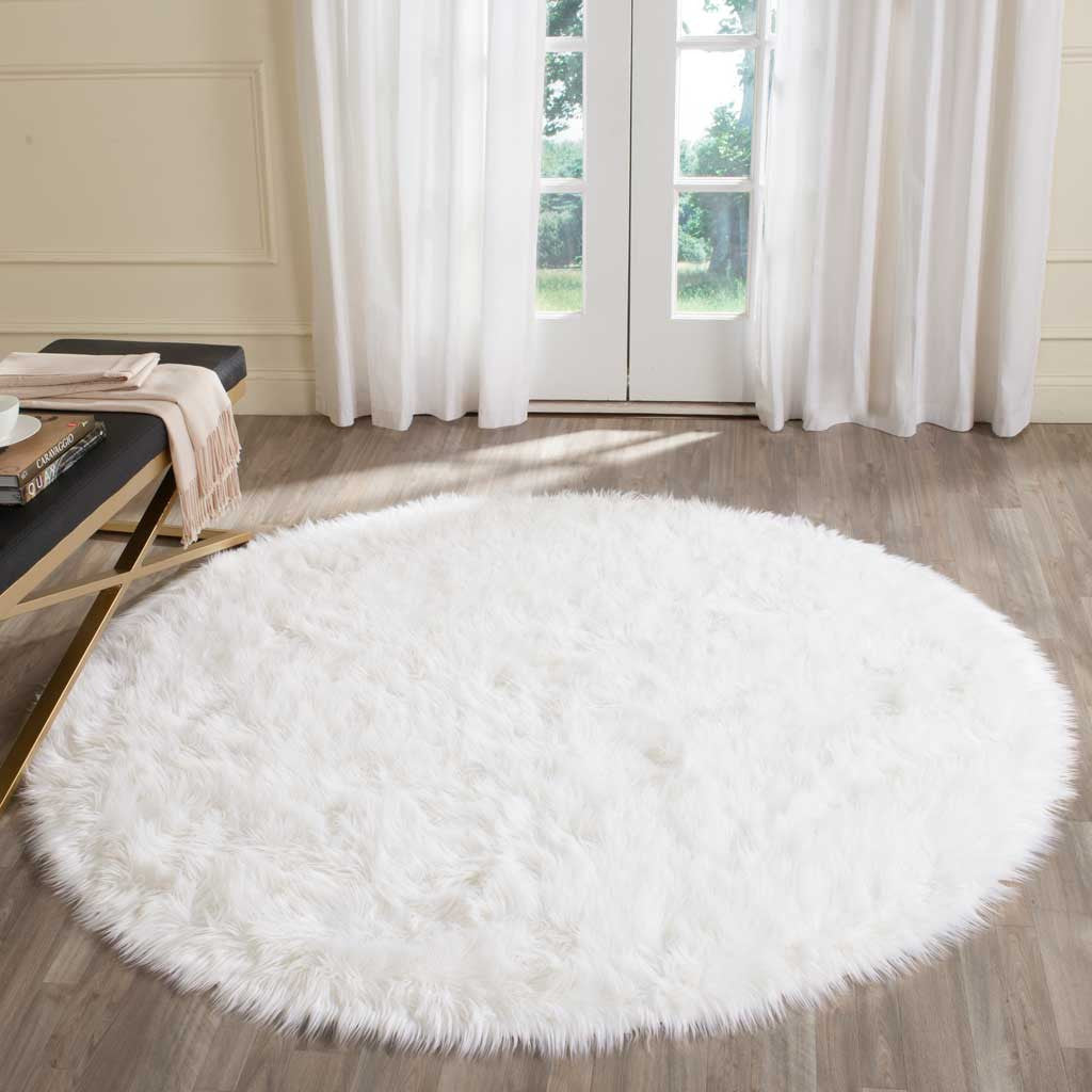 Plush ivory round rug brightens the room with a full, fluffy shag pile