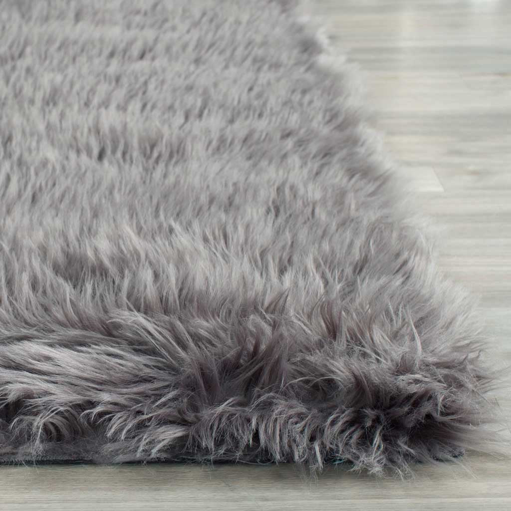 Long gray shag fibers spill over the rug's plush corner for a soft, inviting finish